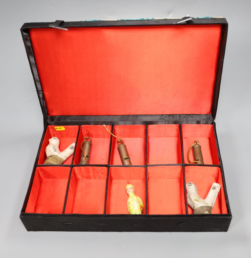 Three Chinese ceramic whistles and three Chinese plated whistles, boxed